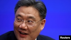 FILE - Chinese Commerce Minister Wang Wentao speaks during a State Council Information Office news conference in Beijing, China, Feb. 24, 2021.