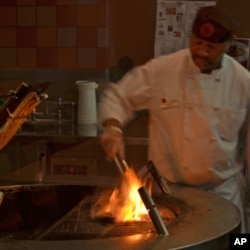 Although most of the food preparation is done one level below the cafeteria, bison and salmon get grilled over an open fire where customers can watch.