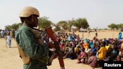 FILE - A soldier stands in guard at the Boudouri site for displaced persons outside the town of Diffa, in southeastern Niger, June 18, 2016. 