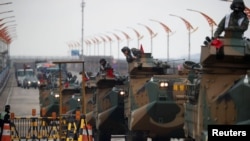 FILE - Amphibious assault vehicles of the South Korean Marine Corps travel during a military exercise as a part of the annual joint military training called Foal Eagle between South Korea and the U.S. in Pohang, South Korea, April 5, 2018. 