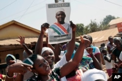 FILE - Gambians celebrate the victory of opposition coalition candidate Adama Barrow against longtime President Yahya Jammeh in the streets of Serrekunda, Gambia, Dec. 2, 2016.