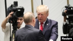 U.S. President Donald Trump and Russian President Vladimir Putin talk before a session of the APEC summit in Danang, Vietnam, Nov. 11, 2017. "We seem to have a very good feeling for each other," Trump said about his relationship with Putin.