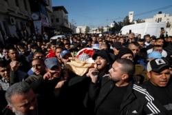 Mourners carry the body of Palestinian Yazan Abu Tabekh, who was killed during an Israeli raid, during his funeral in Jenin in the Israeli-occupied West Bank, Feb. 6, 2020.