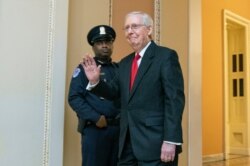 Senate Majority Leader Mitch McConnell, R-Ky., waves as the impeachment trial of President Donald Trump concludes on Capitol Hill in Washington, early Wednesday, Jan. 22, 2020.