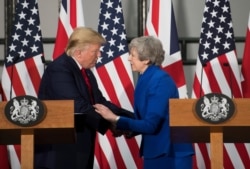 FILE - Britain's Prime Minister Theresa May and U.S. President Donald Trump attend a joint news conference at the Foreign &amp; Commonwealth Office, in London, Britain, June 4, 2019.