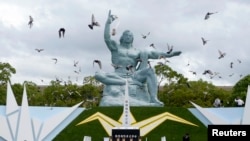 Doves surround the Peace Statue in Nagasaki's Peace Park in a ceremony commemorating the Japanese city's 1945 atomic bombing in photo taken by Kyodo Aug. 9, 2014.