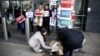 People lay flowers outside New Zealand House, following the Christchurch mosque attacks in New Zealand, in London, March 15, 2019.