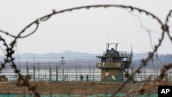 South Korean army soldiers patrol along the barbed-wire fence in Paju, South Korea, near the border with North Korea, on Jan. 5, 2022.