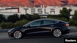 Rescue workers carry Mohammed Bangi, a four-year-old boy, after he was rescued from the rubble at the site of a collapsed five-story building in Mahad in Raigad district in the western state of Maharashtra, India.