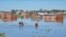People row kayaks on flooded streets in the city of Bahia Blanca, in the province of Buenos Aires, Argentina, March 9, 2025. 