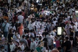 This photo taken on June 10, 2020 shows people visiting an outdoor market in Wuhan in China's central Hubei province.