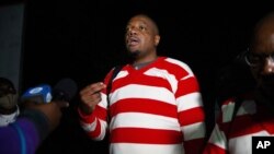 FILE - Zimbabwean investigative journalist Hopewell Chin' ono talks to the media following his release from prison, in Harare, Sept. 3, 2020.