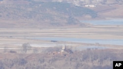 North Korea's town Kaepoong behind a military guard post, bottom, is seen from the unification observatory in Paju, South Korea, Jan. 16, 2024. North Korean leader Kim Jong Un said his country would no longer pursue reconciliation with South Korea.