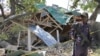 A Somalia soldier stands guard near the destroyed restaurant in Mogadishu, Somalia, Dec. 15, 2016.
