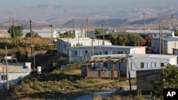 FILE - Amona, an unauthorized Israeli outpost in the West Bank, is seen east of the Palestinian town of Ramallah, Nov. 16, 2016. Amona's fate has divided the Israeli government, putting Prime Minister Benjamin Netanyahu's right-wing coalition in peril.