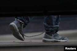 Undocumented immigrants in shackles arrive at a U.S. federal court for hearings in McAllen, Texas, U.S., June 22, 2018.