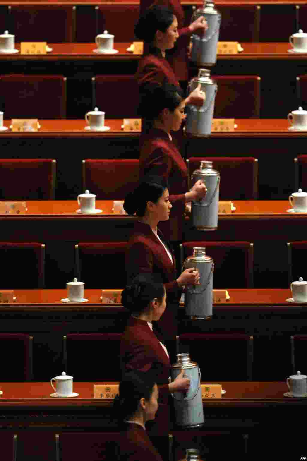 Attendants serve tea before the opening session of the Chinese People's Political Consultative Conference (CPPCC) at the Great Hall of the People in Beijing.
