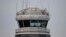 A man gestures inside the control tower of Reagan National Airport after an American Airlines flight crashed into the river after colliding with a US Army helicopter, near Washington, DC, on January 30, 2025.