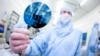 FILE - A scientist presents a silicon wafer.