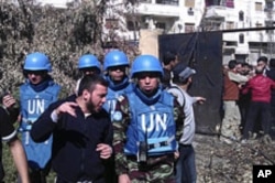 Members of the first U.N. monitoring team, together with members of the Syrian Free Army, visit Homs, Syria, April 21, 2012.