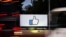 FILE - The entrance sign to Facebook headquarters is seen through two moving buses in Menlo Park, California, Oct. 10, 2018.