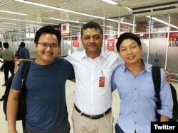 Myanmar photojournalists Minzayar Oo and Hkun Lat, who were arrested in Bangladesh, are seen with their lawyer in a photo posted on Twitter, Oct. 17, 2017.