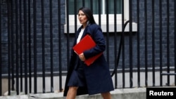 FILE - Priti Patel, Britain's secretary of state for international development arrives in Downing Street, in London, October 31, 2017.