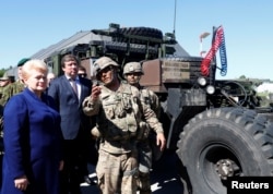Lithuania's President Dalia Grybauskaite listens to U.S. soldiers next to a Patriot missle system during Toburq Legacy 2017, an air defense exercise, in a military airfield near Siauliai, Lithuania, July 20, 2017.