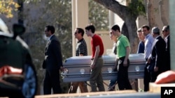 Pall bearers carry the casket of Scott Beigel after his funeral in Boca Raton, Florida, Feb. 18, 2018. 