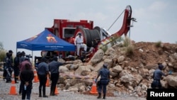 Members of the South African police, patrol as they guard the mine shaft where rescue operations are ongoing as attempts are made to rescue illegal miners who have been underground for months in Stilfontein, South Africa, Jan. 14, 2025.