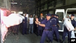 FILE - Policemen are seen incinerating narcotics seized in a drug busts in the Montenegrin capital, Podgorica.