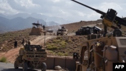 U.S. Army from NATO and Afghan commando forces are seen in a checkpoint during a patrol against Islamic State militants at the Deh Bala district in the eastern province of Nangarhar Province, July 7, 2018.