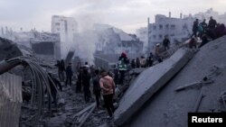 Palestinians gather at the site of an Israeli strike on houses in Gaza City on Jan. 4, 2025.