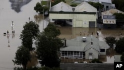 People wade through flood waters in the town of Moree, Northern New South Wales, Australia. (File Photo - February 3, 2012) 