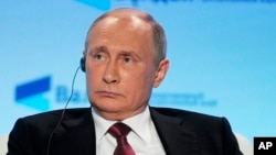 FILE - Russian President Vladimir Putin attends a meeting of the Valdai International Discussion Club in Sochi, Russia, Oct. 27, 2016.