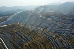 FILE - A solar panel installation is seen in Ruicheng County in central China's Shanxi Province, Nov. 27, 2019.