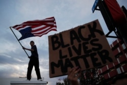 FILE - Protesters rally in Las Vegas, Nevada, May 30, 2020, over the death of George Floyd, a black man who was in police custody in Minneapolis. The Boogaloo Boys are accused of using demonstrations to incite chaos.