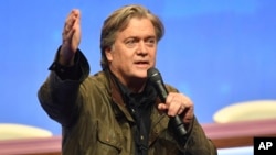 Former White House strategist Steve Bannon addresses members of the far-right National Front party at the party congress in the northern French city of Lille, March 10, 2018. 
