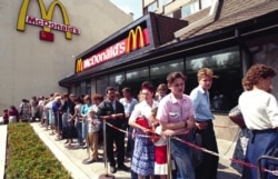 FILE - In this photo taken in 1991, Russians wait in line outside a McDonald's fast food restaurant in Moscow.
