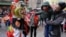 A lion dancer from the Tai Pun Residents Association accepts an offering in a red envelope during a Lunar New Year celebration, in New York's Chinatown neighborhood, Feb. 8, 2016.