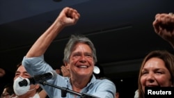 Ecuadorean banker Guillermo Lasso and his wife, María de Lourdes Alcívar, react after Lasso wins the presidential runoff vote, in Guayaquil, Ecuador, April 11, 2021.