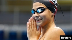 FILE - Syrian refugee team swimmer Yusra Mardini, 18, practices at the Olympic swimming venue at Olympic Park in Rio de Janeiro, Brazil, Jan. 8, 2016.