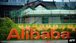 Workers renovate a building at the Alibaba head office in Hangzhou, east China's Zhejiang province, Sept. 15, 2014. 