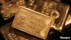 FILE - Gold bars are displayed at a gold jewelry shop in the northern Indian city of Chandigarh. 