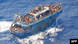 This image released by The Hellenic Coast Guard on June 14, 2023, shows an aerial view from a rescue helicopter of migrants on board a fishing vessel in the waters off the coast of Greece on June 13, 2023.