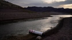 A buoy once used to warn of a submerged rock rests on the ground along the waterline near a closed boat ramp on Lake Mead at the Lake Mead National Recreation Area, Friday, Aug. 13, 2021, near Boulder City, Nev. Water levels at Lake Mead, the…