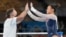 Sunisa Lee, of the United States, greets her coach Jeff Graba after performing on the uneven bars during the artistic gymnastics women's all-around final at the 2020 Summer Olympics, July 29, 2021, in Tokyo.