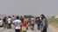 Displaced families from the minority Yazidi religious group, fleeing the violence, are seen on the outskirts of Sinjar, west of Mosul, Iraq, August 5, 2014.