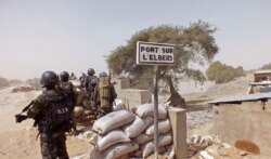 FILE - Cameroonian soldiers stand guard at a lookout post as they take part in operations against Boko Haram militants on Elbeid bridge that separates northern Cameroon form Nigeria's Borno state near the village of Fotokol, Cameroon, Feb. 25, 2015.