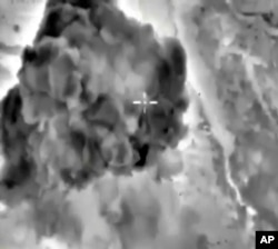 In this photo made from the footage taken from Russian Defense Ministry official web site on Oct. 3, 2015 a bomb explosion is seen in Syria.